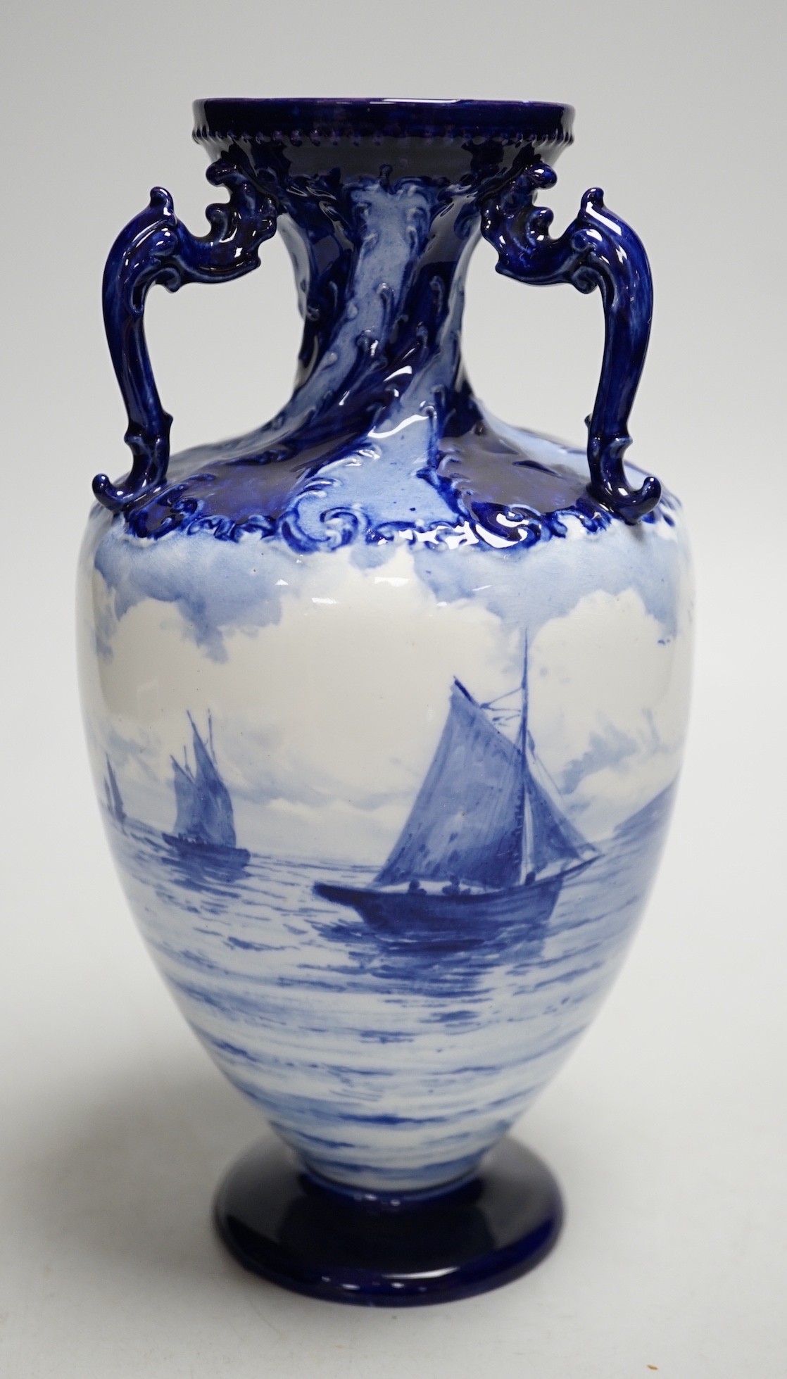 A Royal Crown Derby blue and white vase painted with shipping scenes by WEJ Dean. 22cm tall